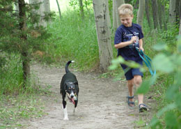 Boy running with dog