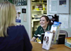 Vet nurse with customer at reception